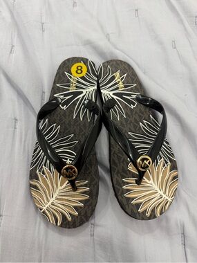 Michael Kors Black and Brown Tropical Logo Flip Flops